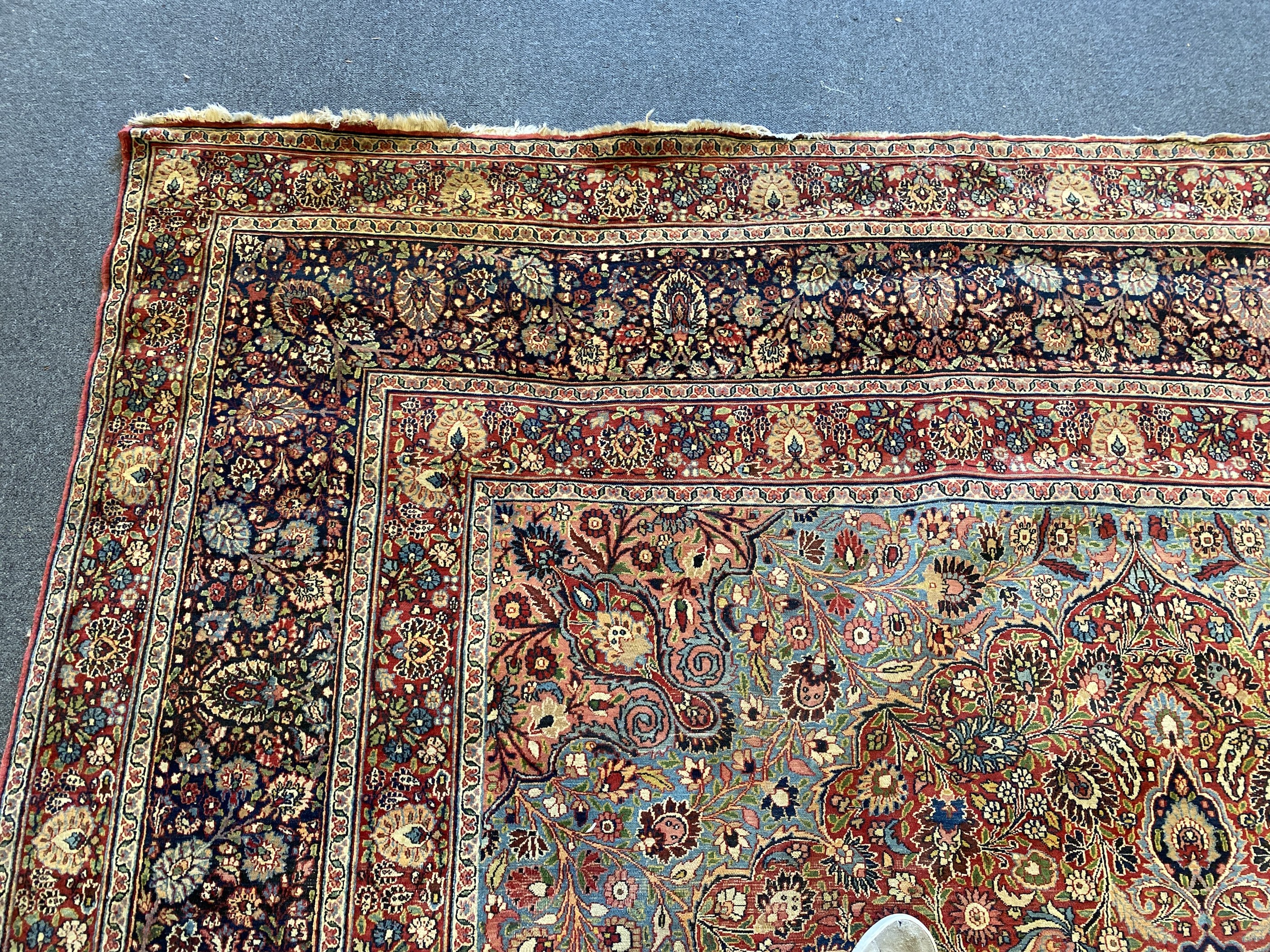 A large Persian blue ground carpet, 395 x 305cm